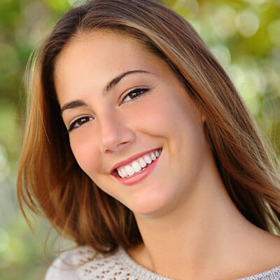 A young woman smiling with perfect teeth