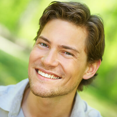 A young man smiling with a smile makeover