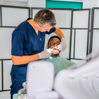 Dentist assessing a patient’s dental crown